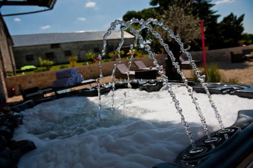 a swing pool with snow and water at Le Prieuré Chambres d'hôtes in Sainte-Preuve
