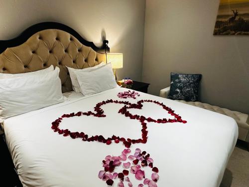 a heart made out of flowers on a bed at Kings View Exclusive Villas (KVEV) in Petronella