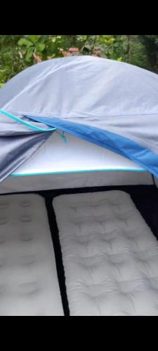 a tent that is open with a mattress at Mistyland in Mamalakandam