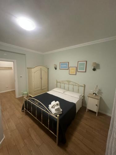 a bedroom with a bed with a black and white blanket at Casa Gioia in Taranto