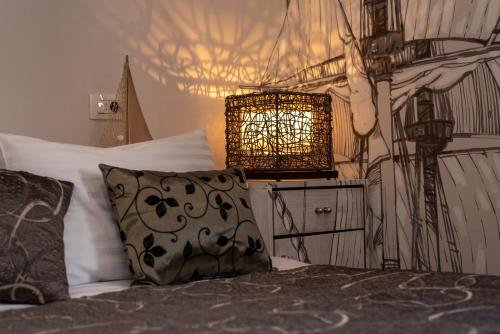 a bedroom with a bed with a pillow and a lamp at Capital Luxury Rooms Split in Split