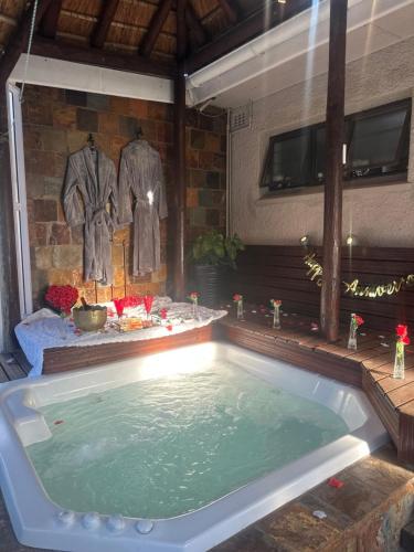 a jacuzzi tub in a room with at House of Royalty in Gqeberha