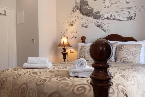 a bedroom with a bed with towels on it at Capital Luxury Rooms Split in Split