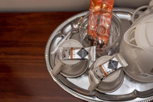 a silver tray with plates and a bottle on it at Capital Luxury Rooms Split in Split