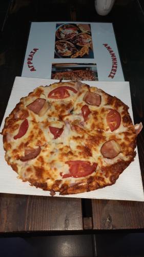 a pepperoni pizza sitting on top of a table at Agrelia in Agreliá