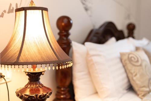 a lamp sitting on a table next to a bed at Capital Luxury Rooms Split in Split