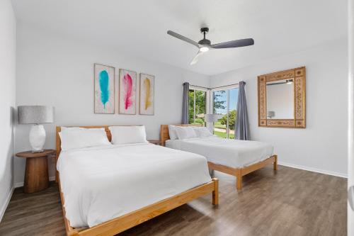 a bedroom with two beds and a ceiling fan at 5br Getaway Near Plaza Dist Patio & Lounge #mr in Warr Acres