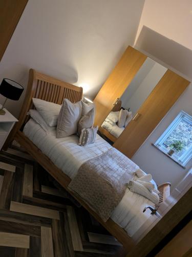 a bedroom with a bed with a wooden frame at Cavehill city view in Belfast