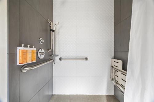 a shower stall in a bathroom with white tiles at Hotel EPIK in San Francisco