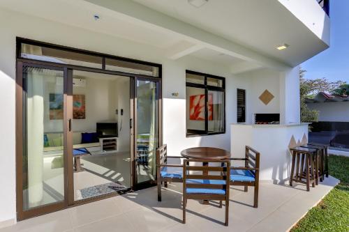 a dining room with glass doors and a table and chairs at Hotel Sete Ilhas in Florianópolis