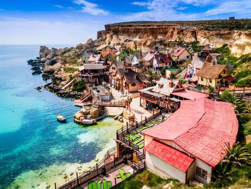 an aerial view of a village on the side of a cliff at Elise Apartments in Il-Gżira