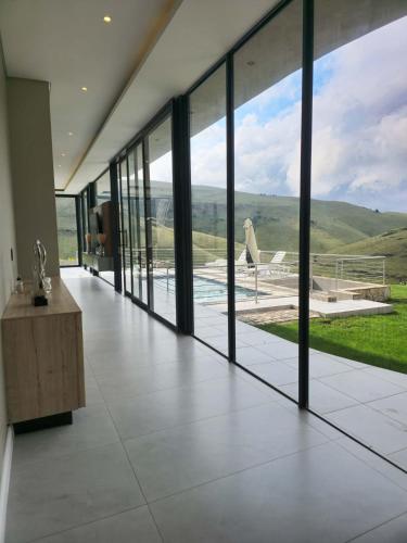 a large room with glass doors and a view at The Curve in Dullstroom