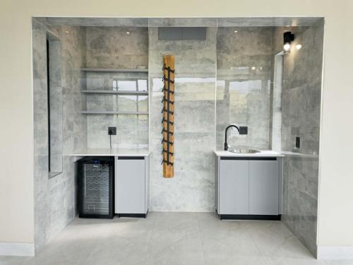 a bathroom with a sink and a counter and a mirror at The Curve in Dullstroom