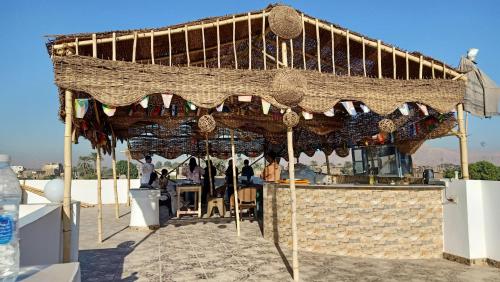 a restaurant with awning on top of a building at Dream Garden Luxor in Luxor