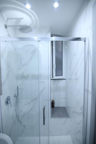 a bathroom with a shower with a glass door at Terrazza 19 in Naples
