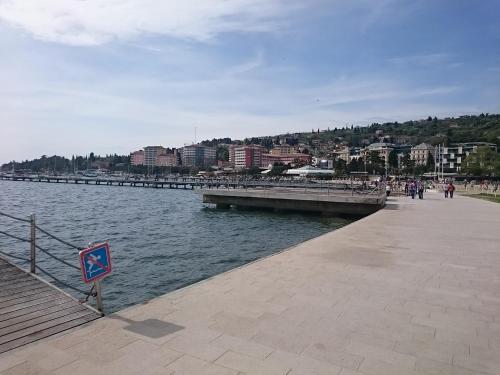 a pier next to a body of water with buildings at Guest house Vila Luka 2 in Portorož