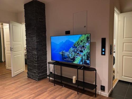 a flat screen tv sitting in a living room at Top apartment with a view in Tromsø