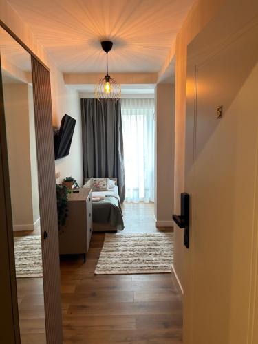 a hallway with a room with a bed and a window at Willa Jelitkowska in Gdańsk