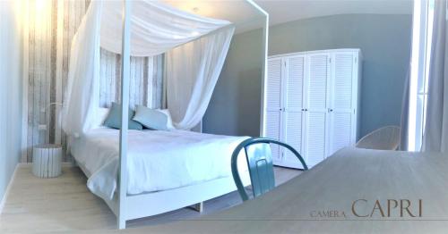 a bedroom with a canopy bed and a mirror at B&b Torre del Greco in Torre del Greco