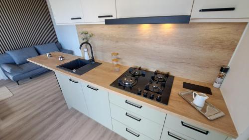 a kitchen with a stove top and a sink at Perferct Day Mobile Home in Drage