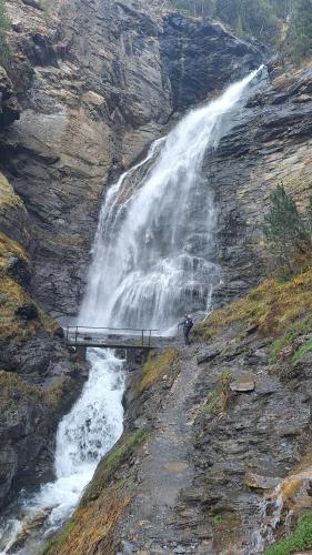a waterfall on the side of a rocky mountain at Rincón de Cerler in Cerler