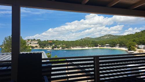 a view of a beach from a balcony at Perferct Day Mobile Home in Drage