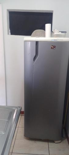 a small refrigerator in a kitchen with a counter at Qto privativo em Duplex a 5km do carnaval in Olinda
