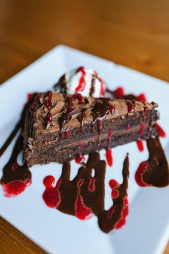 a piece of chocolate cake on a white plate at Wellness hotel & minipivovar Kněžínek in České Budějovice