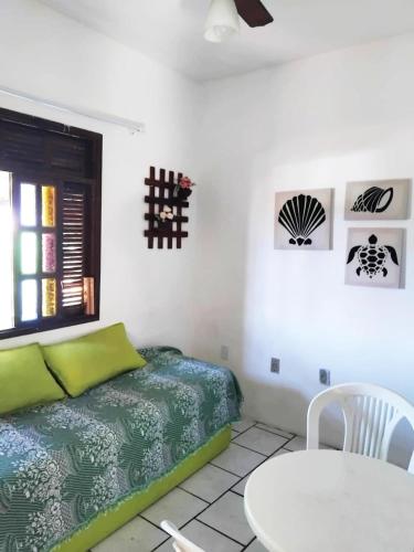 a white room with a bed and a table at pousada mar azul in Salvador