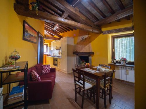 a kitchen and living room with a table and chairs at appartamento LE LOGGE in Montefiascone