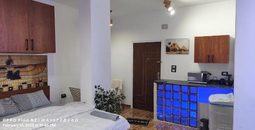 a room with a bed and a kitchen with a counter at Gamgom Studio in Cairo