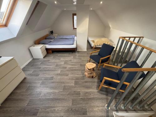 a attic room with a bed and a staircase at Chata pro dva nebo pro celou rodinu in Slavníč