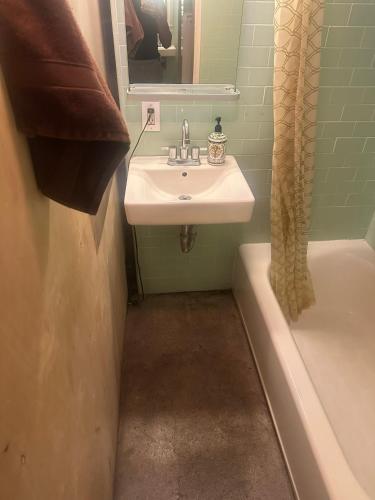 a bathroom with a sink and a bath tub at PodShare San Diego in San Diego