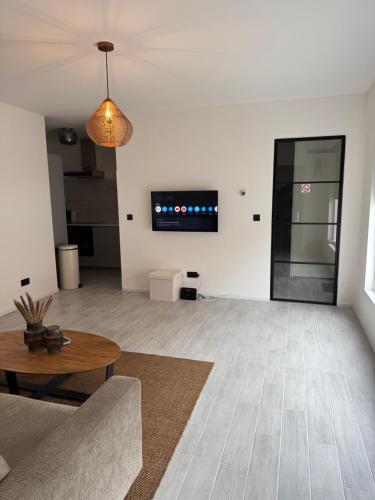 a living room with a couch and a table at Smile home 3 Wormerveer- Zaanse Schans en Amsterdam appartements in Wormerveer