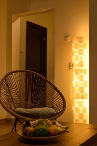 a chair on a table with a plate of food at AeroVista Apartment in Surčin