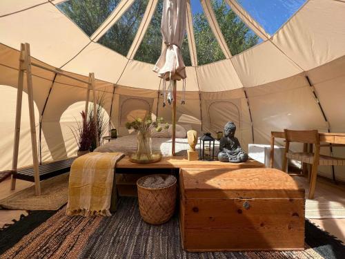 a tent with a table and a statue in it at Bramslev Bakker Naturhotel in Hobro