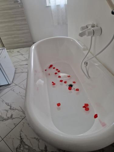 a white bathroom sink with hearts on it at Eden in Lamezia Terme
