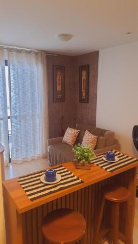 a living room with a couch and a table at nityloft com piscina e academia em Icaraí in Niterói
