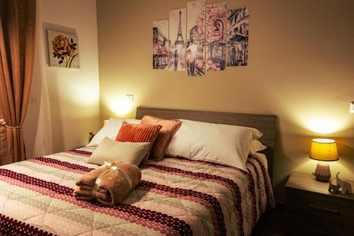 a bedroom with a bed with two pictures on the wall at Torre dei Venti in Ceccano