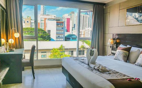 Ένα ή περισσότερα κρεβάτια σε δωμάτιο στο Boss Suites Nana Hotel