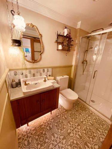 a bathroom with a sink and a toilet and a shower at The Botanist in New Plymouth