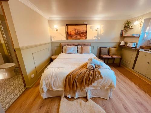 a bedroom with a bed with a teddy bear on it at The Botanist in New Plymouth