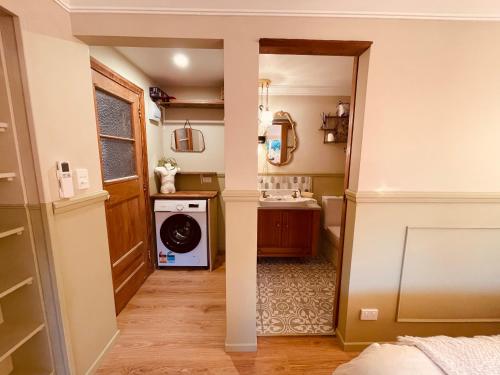 a hallway of a home with a washer and dryer at The Botanist in New Plymouth