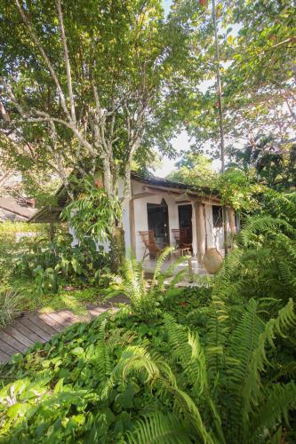 a small house in the middle of a garden at Pousada Quinta de Caraíva in Porto Seguro