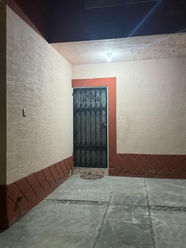 an empty room with a black door in a building at Departamentos Ramos Arizpe Saltillo Facturable in Ramos Arizpe
