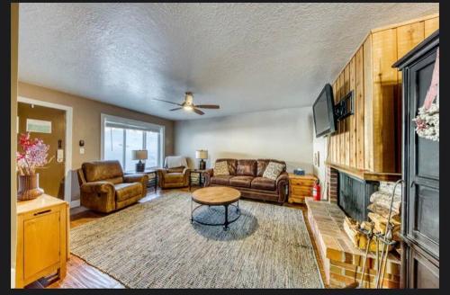 a living room with a couch and a fireplace at Charming Family Condo, Spacious-Prestige Vacations in Brian Head