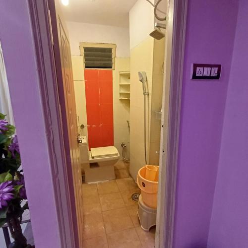 a small bathroom with a toilet and a sink at A K Home's 2BHK flat in Hyderabad