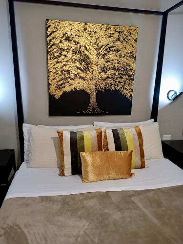 a bedroom with a white bed with a painting on the wall at Casa nicola- apt in the heart of Rome in Rome