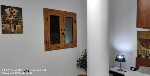a wooden door on a white wall in a room at Gamgom Studio in Cairo