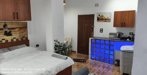 a bedroom with a bed and a counter with blue boxes at Gamgom Studio in Cairo